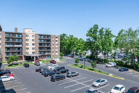 an aerial view of a parking lot with cars