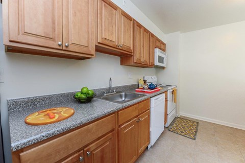 a kitchen with wooden cabinets and a sink
