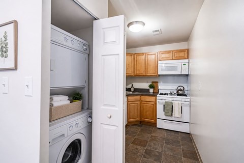 A small kitchen with a washer and dryer built into the wall.