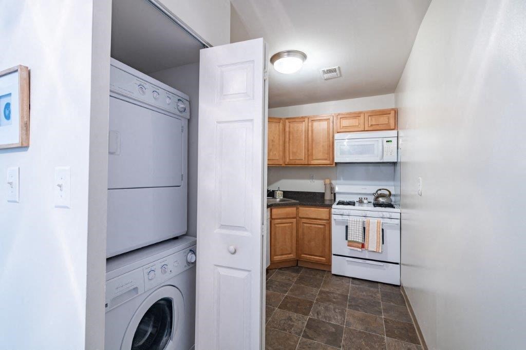 a kitchen with a washer and dryer and a sink