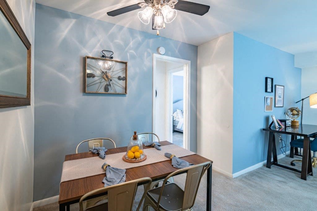 a dining room with a table and a ceiling fan