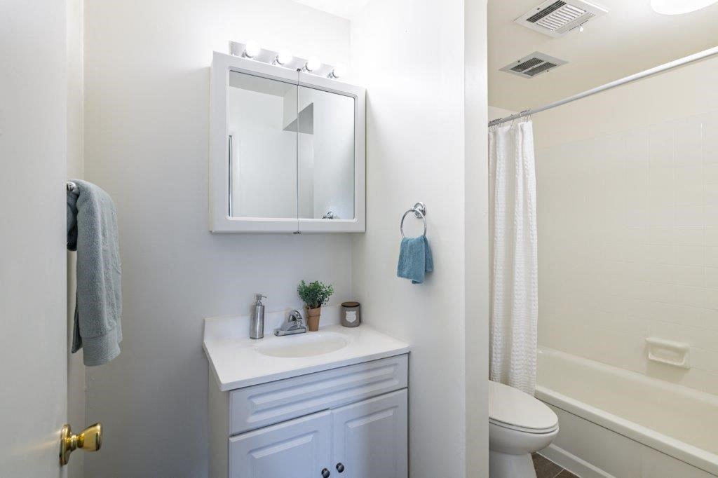 a bathroom with a sink and a mirror and a shower