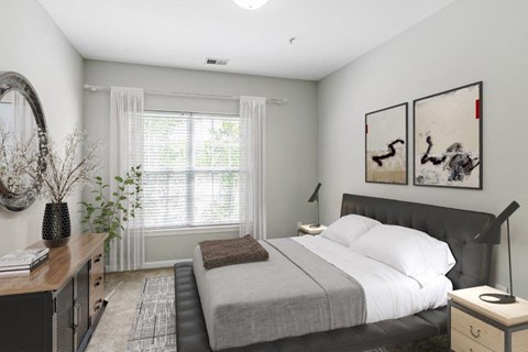 a bedroom with a bed and two paintings on the wall