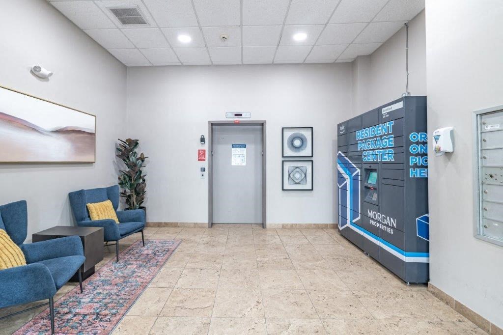 the lobby of a building with a vending machine and chairs