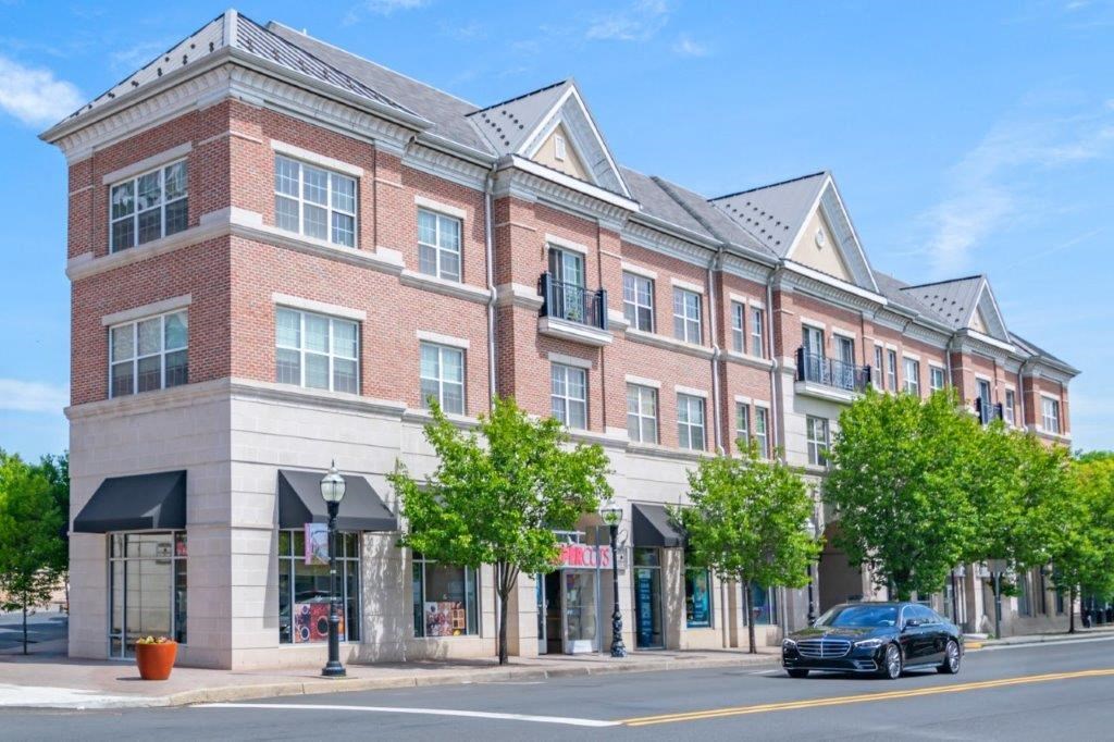 a large brick building on a city street with a car