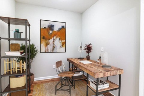 a home office with a desk and a book shelf