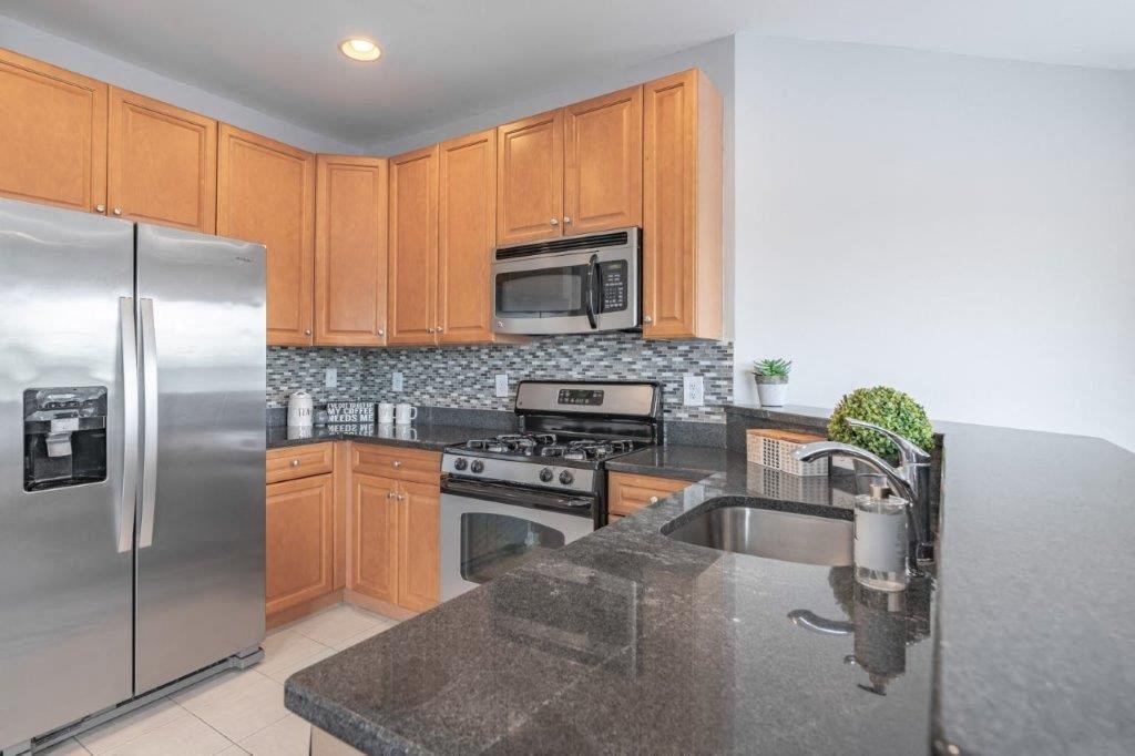 a kitchen with stainless steel appliances and granite counter tops
