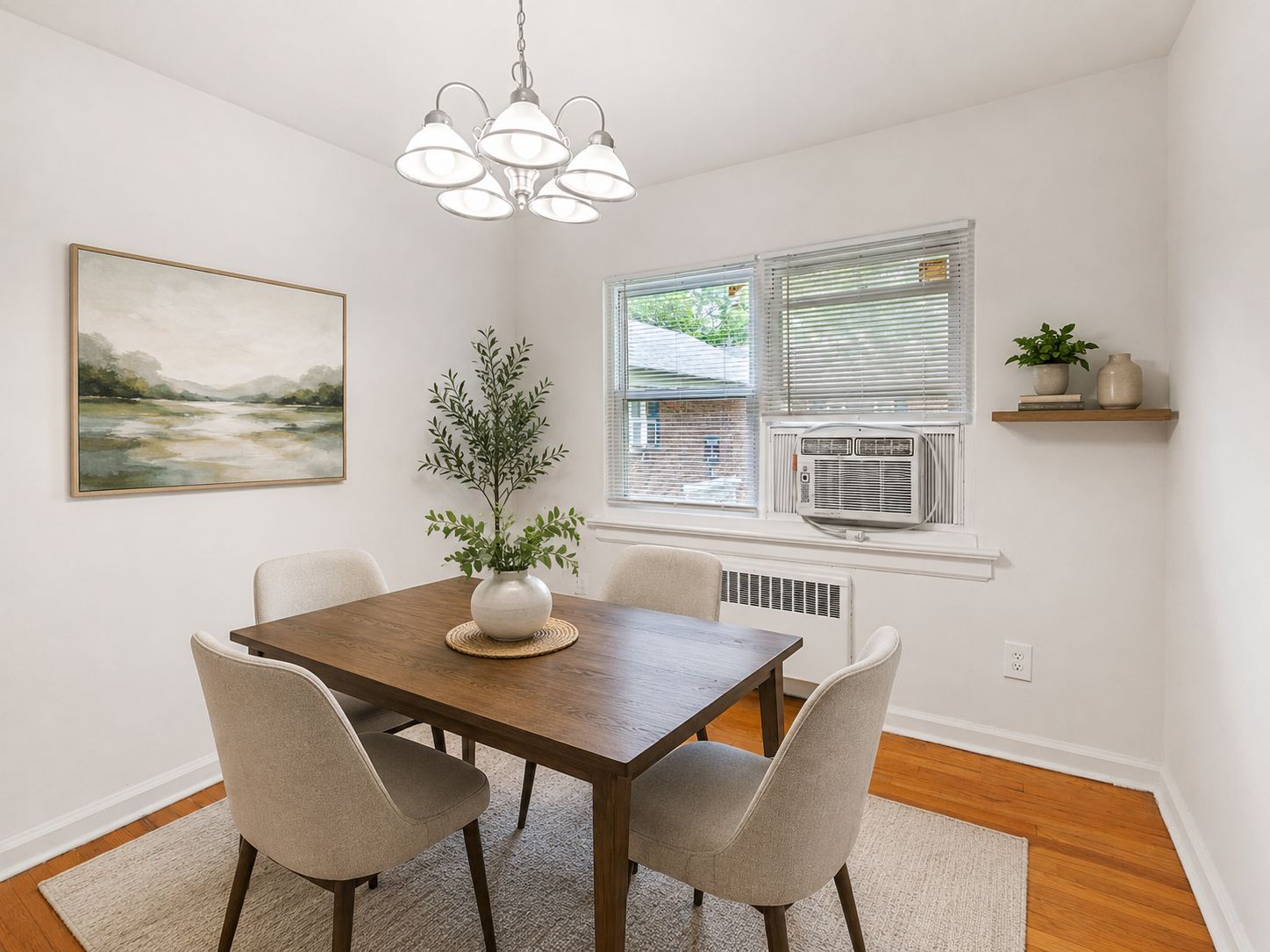 A dining room with a wooden table and chairs.