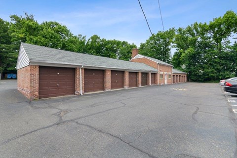 a row of garages on the side of a parking lot
