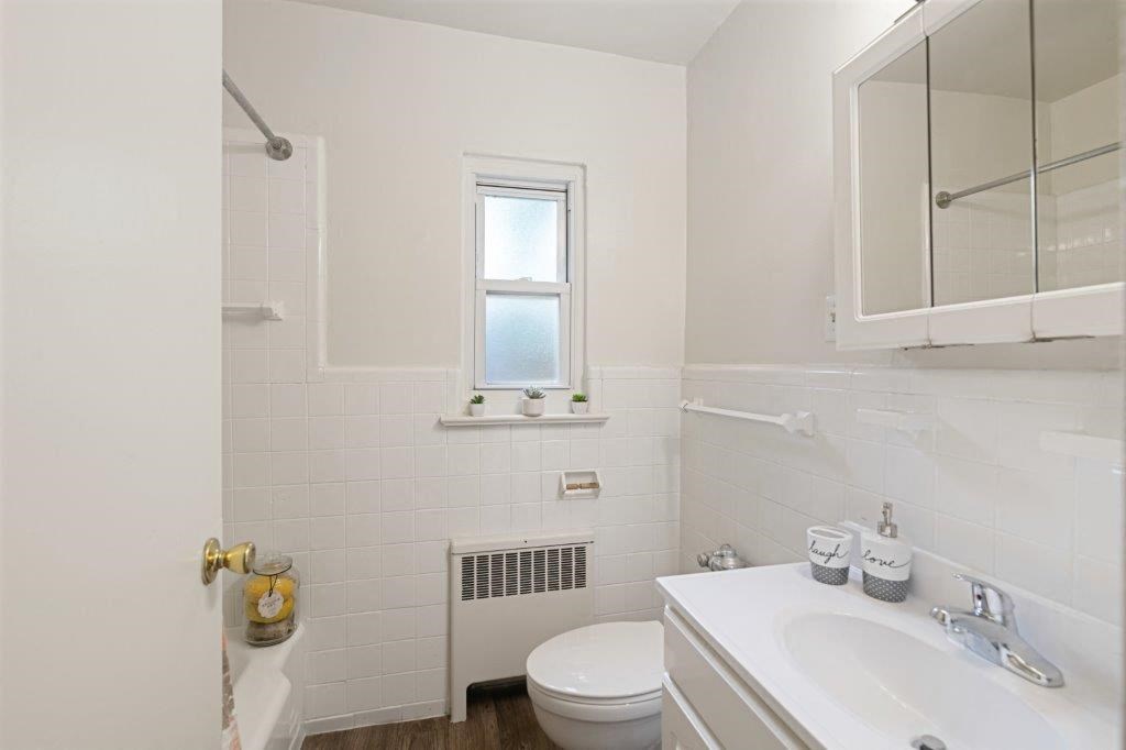 a bathroom with a sink toilet and a mirror