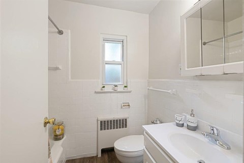 a bathroom with a sink toilet and a mirror