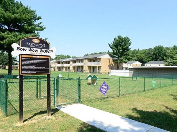 a sign for the bow wow wow dog park in front of a fence