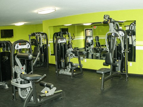 a workout room with weights and cardio equipment in a gym