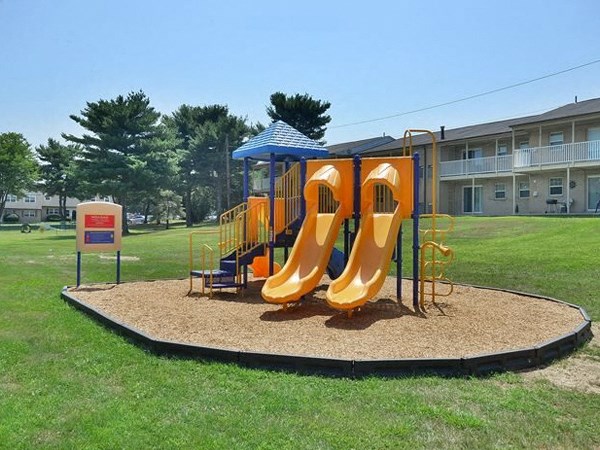 a playground with a swing set in a park
