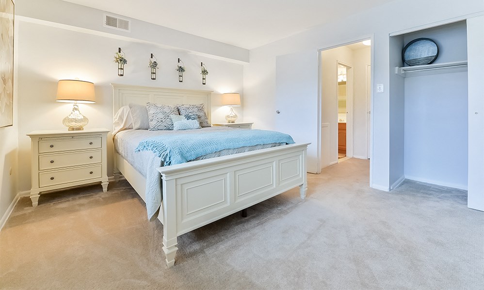 a bedroom with a bed and two night stands