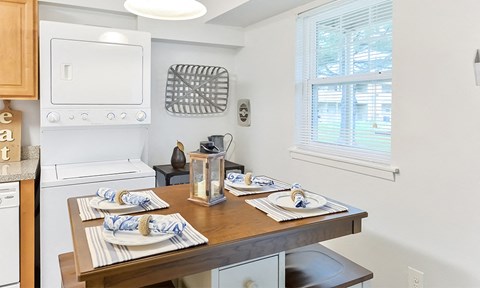 a kitchen with a dining table and a washer and dryer