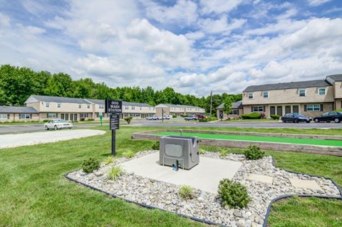 a mailbox in the middle of a street with apartments in the background