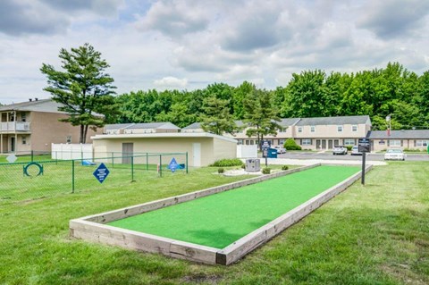 a park with a green turf field and a playground