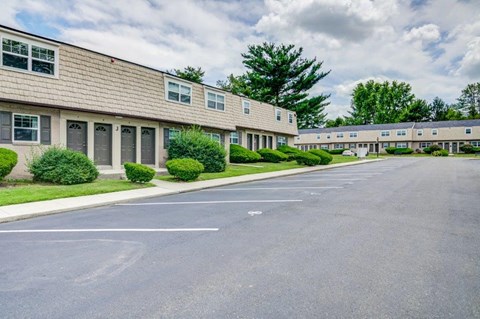 an empty parking lot in front of an apartment building