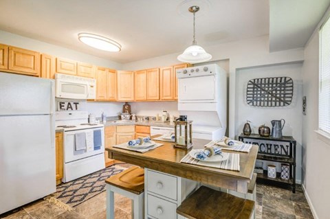 a kitchen with white appliances and wooden cabinets
