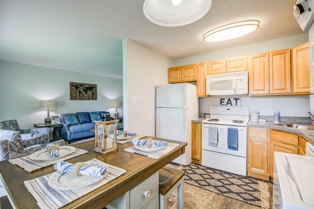 a kitchen and living room with a dining table