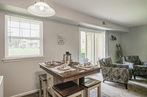 a dining room with a table and chairs