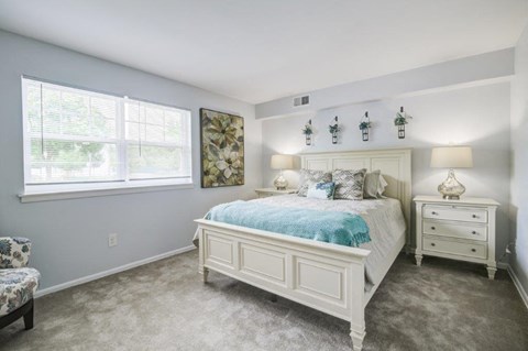 a bedroom with a bed and a window