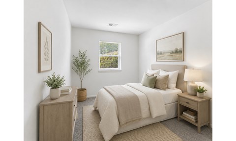 A bedroom with a bed, nightstand, and a plant.