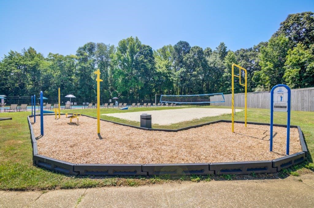a playground with a volleyball court in a park