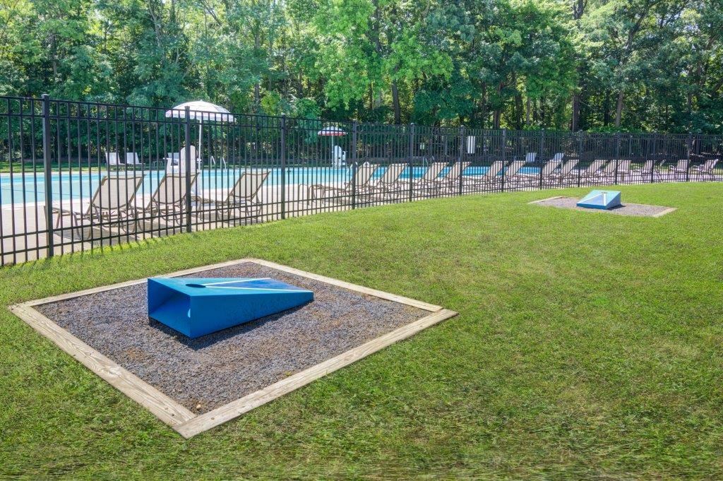 a fenced in swimming pool with a blue pool table