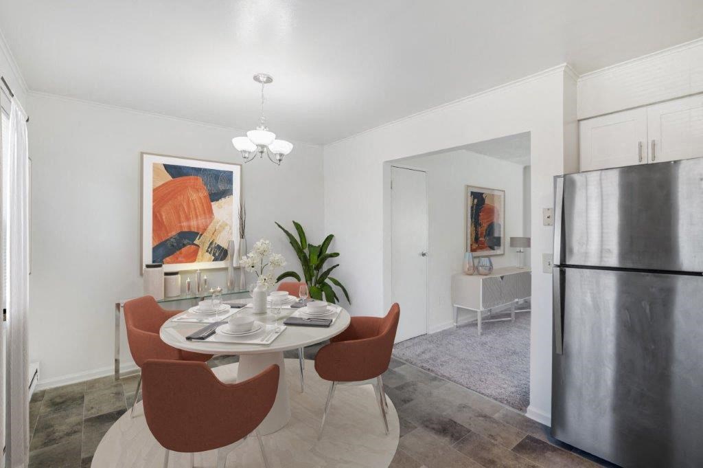 a kitchen and dining room with a table and chairs