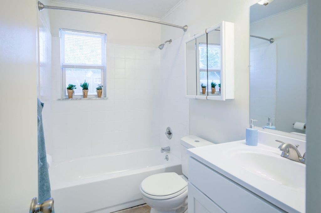 a bathroom with a sink toilet and a bath tub