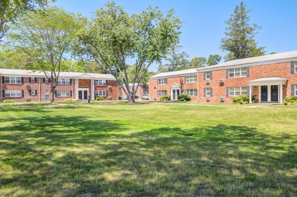 a large lawn in front of a brick building