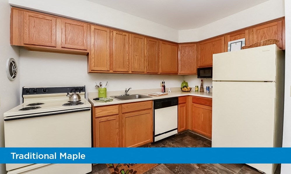a kitchen with white appliances and wooden cabinets