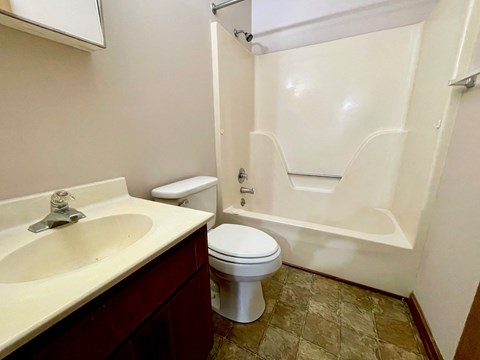 a bathroom with a sink toilet and a tub