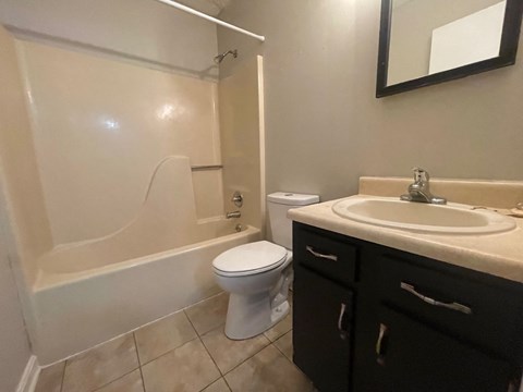 a bathroom with a sink toilet and a bath tub