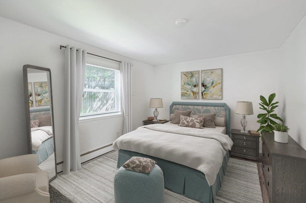 a bedroom with a bed and a dresser and a mirror