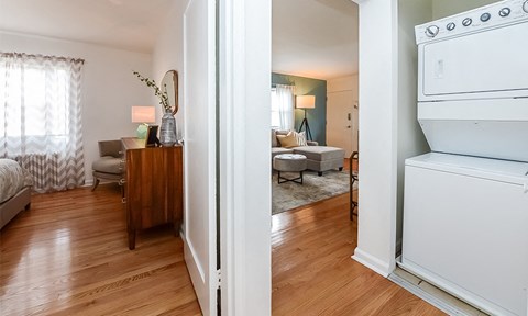 the view of the living room from the kitchen and the dining room of a apartment
