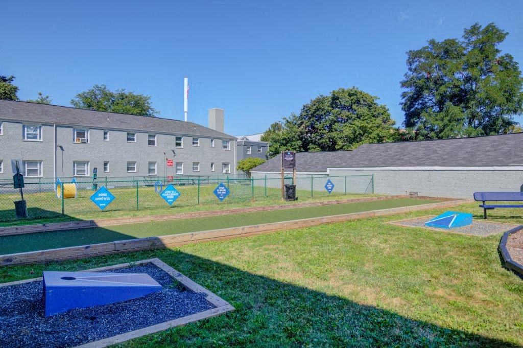 a park with a mini golf course and houses in the background