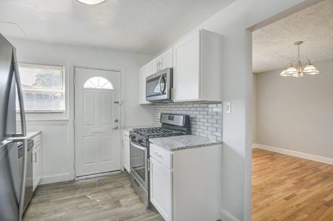 a kitchen with a stove and a microwave