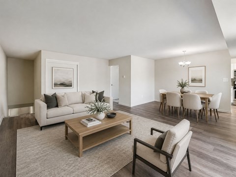 A living room with a couch, chairs, and a coffee table.
