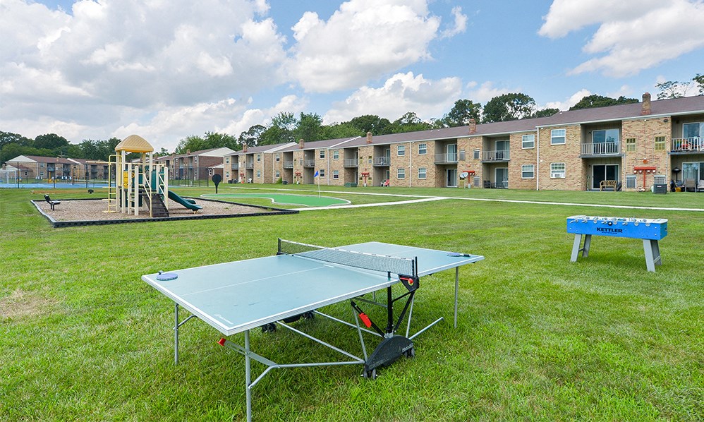 a ping pong table in front of an apartment complex