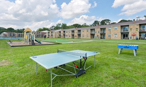 a ping pong table in front of an apartment complex