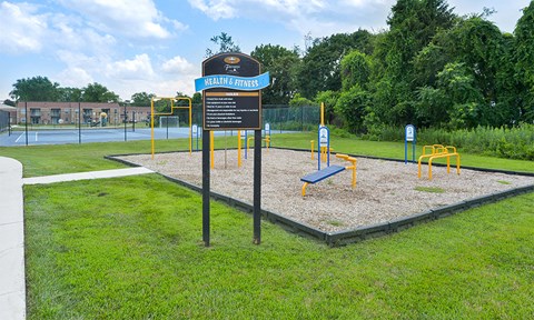 a park with a playground and a sign