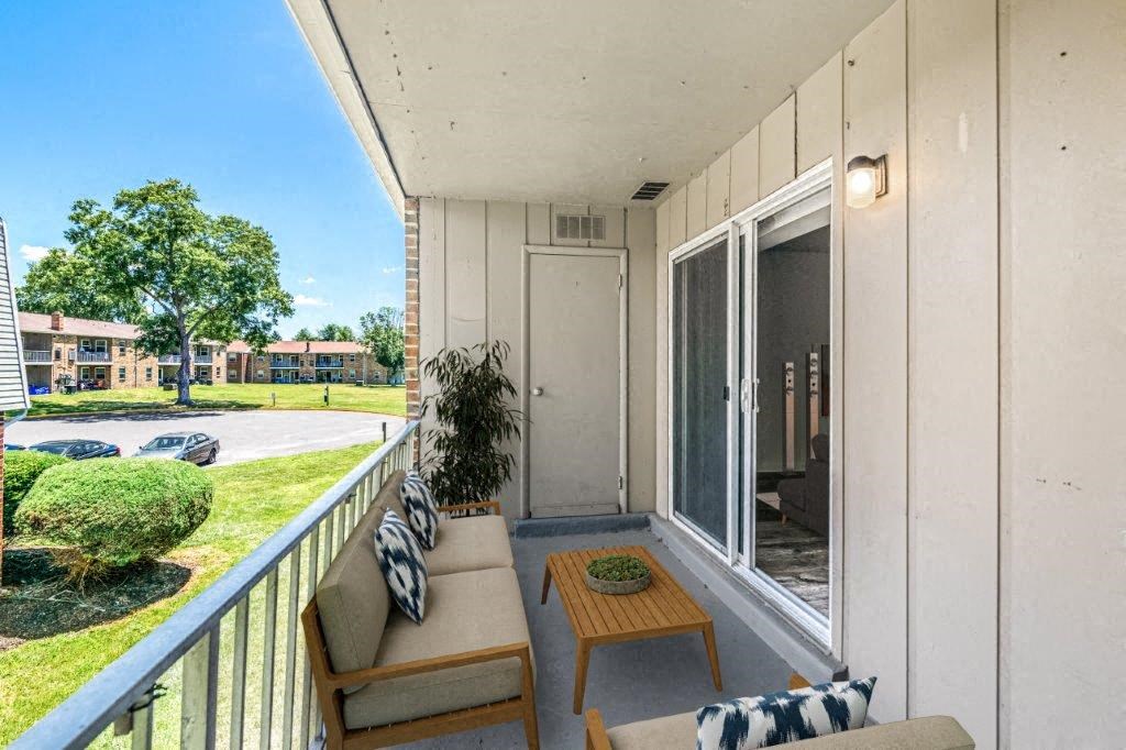 a balcony with two couches and a table