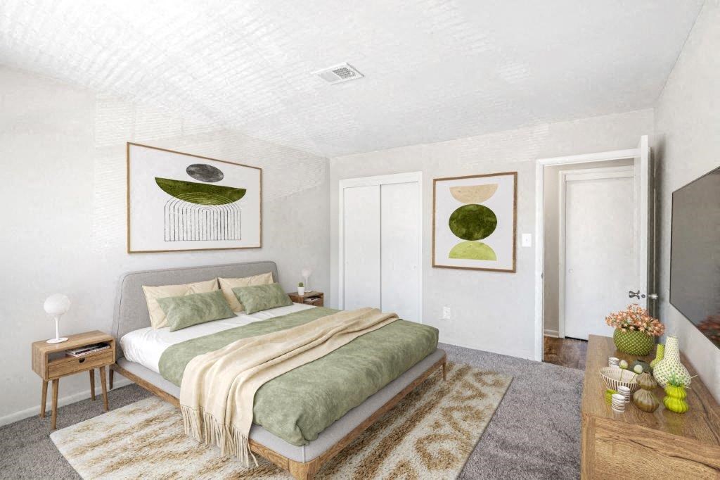 a bedroom with a bed and pictures on the wall