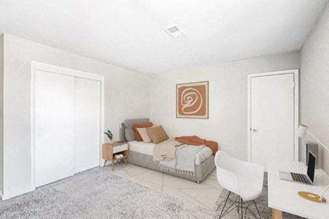 a bedroom with a bed and a desk with a chair