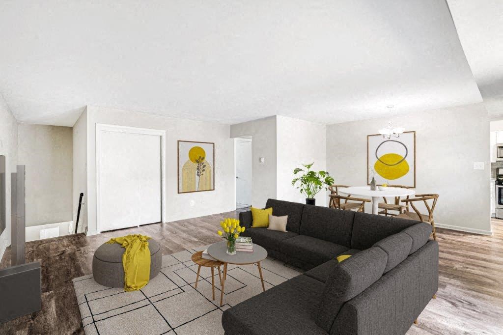 a living room with a black couch and a table