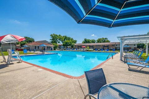 our resort style swimming pool is open to the community and has lounge chairs and tables
