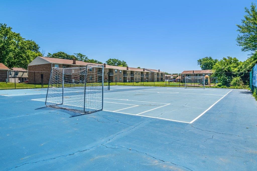a tennis court with a net in front of a building